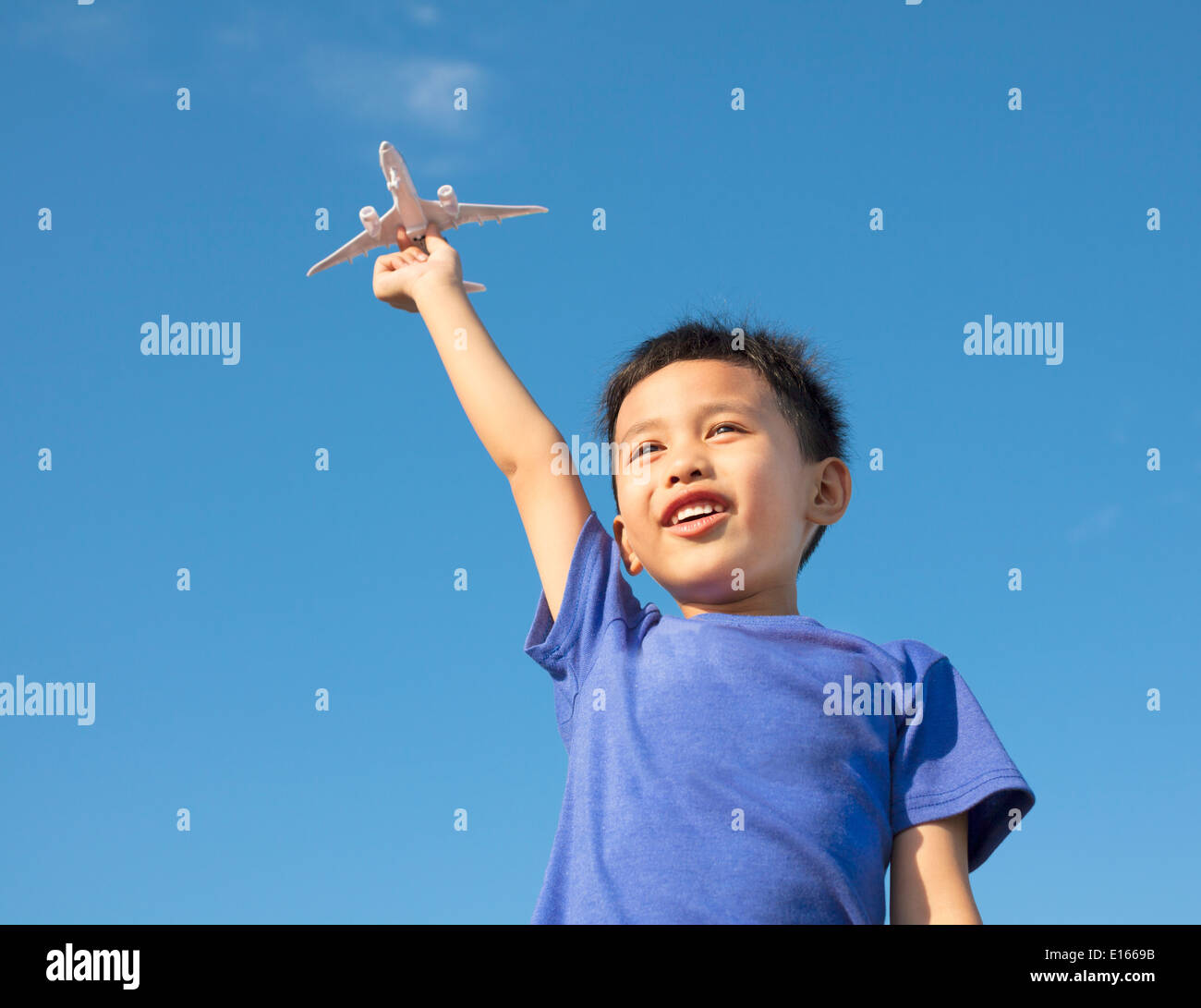 happy boy holding a airplane toy with blue sky Stock Photo - Alamy