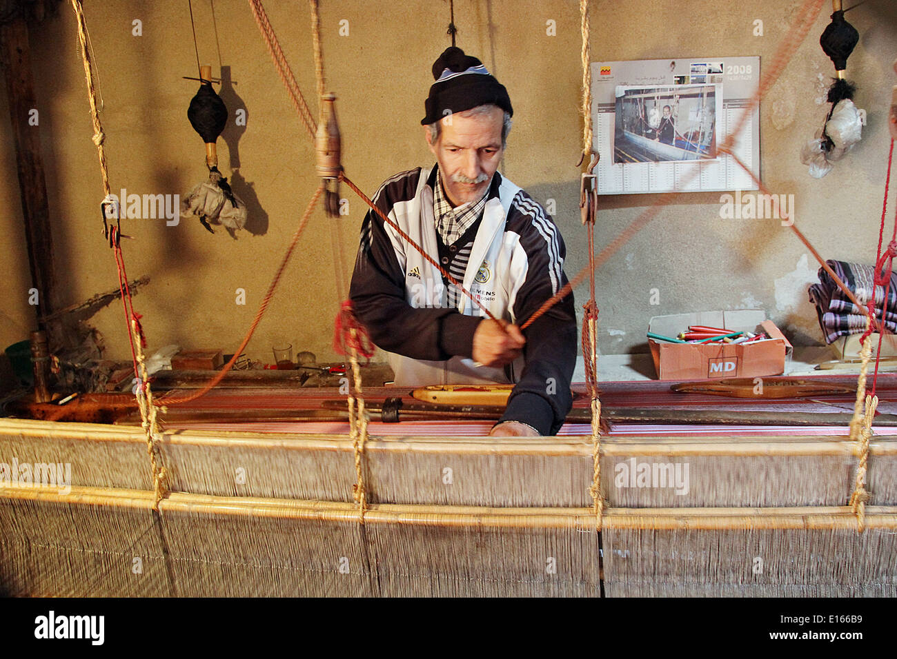 Man in Fes weaving silk cloth Stock Photo