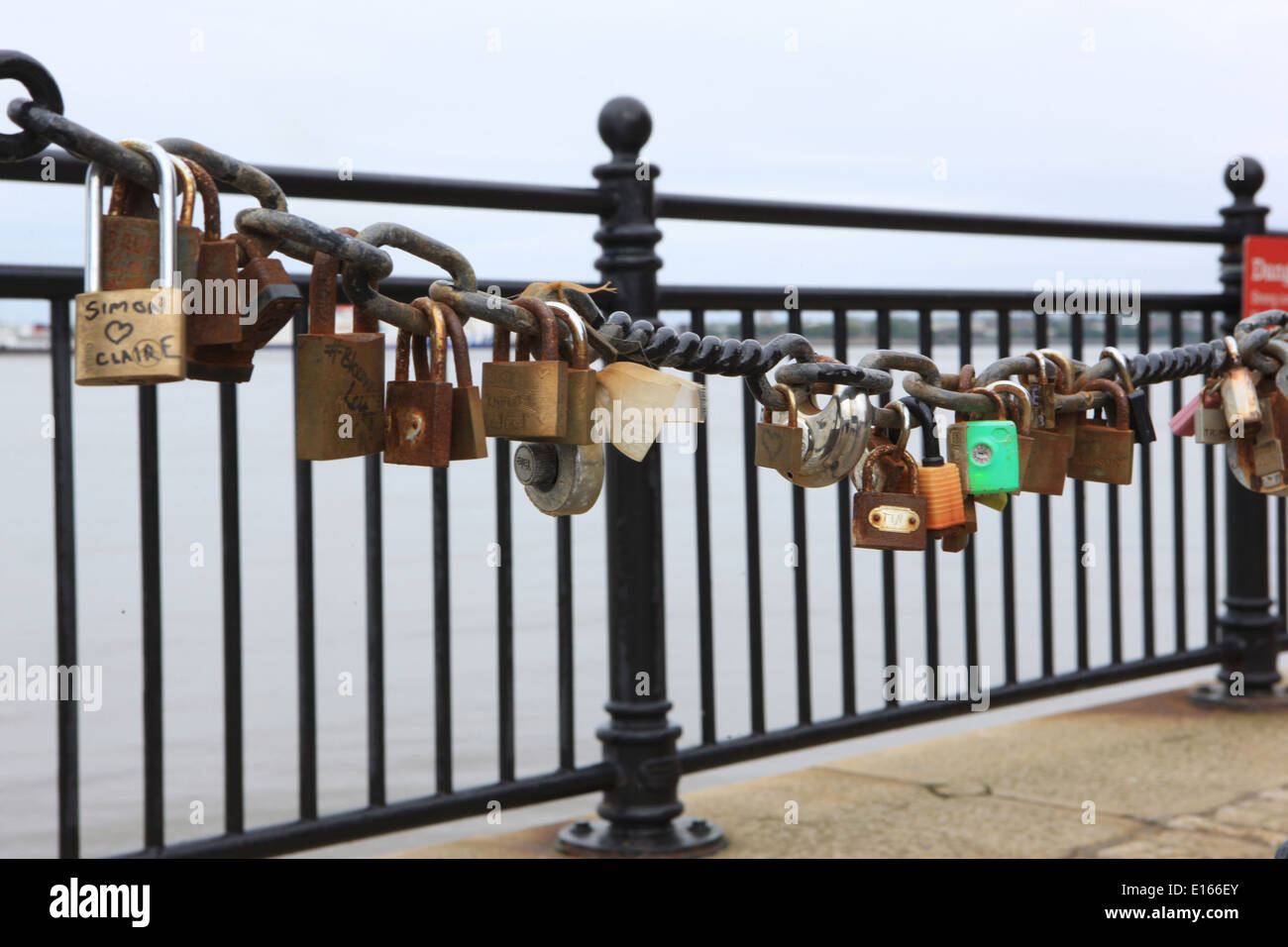 Some of the thousands of padlocks on railing beside the River Mersey in