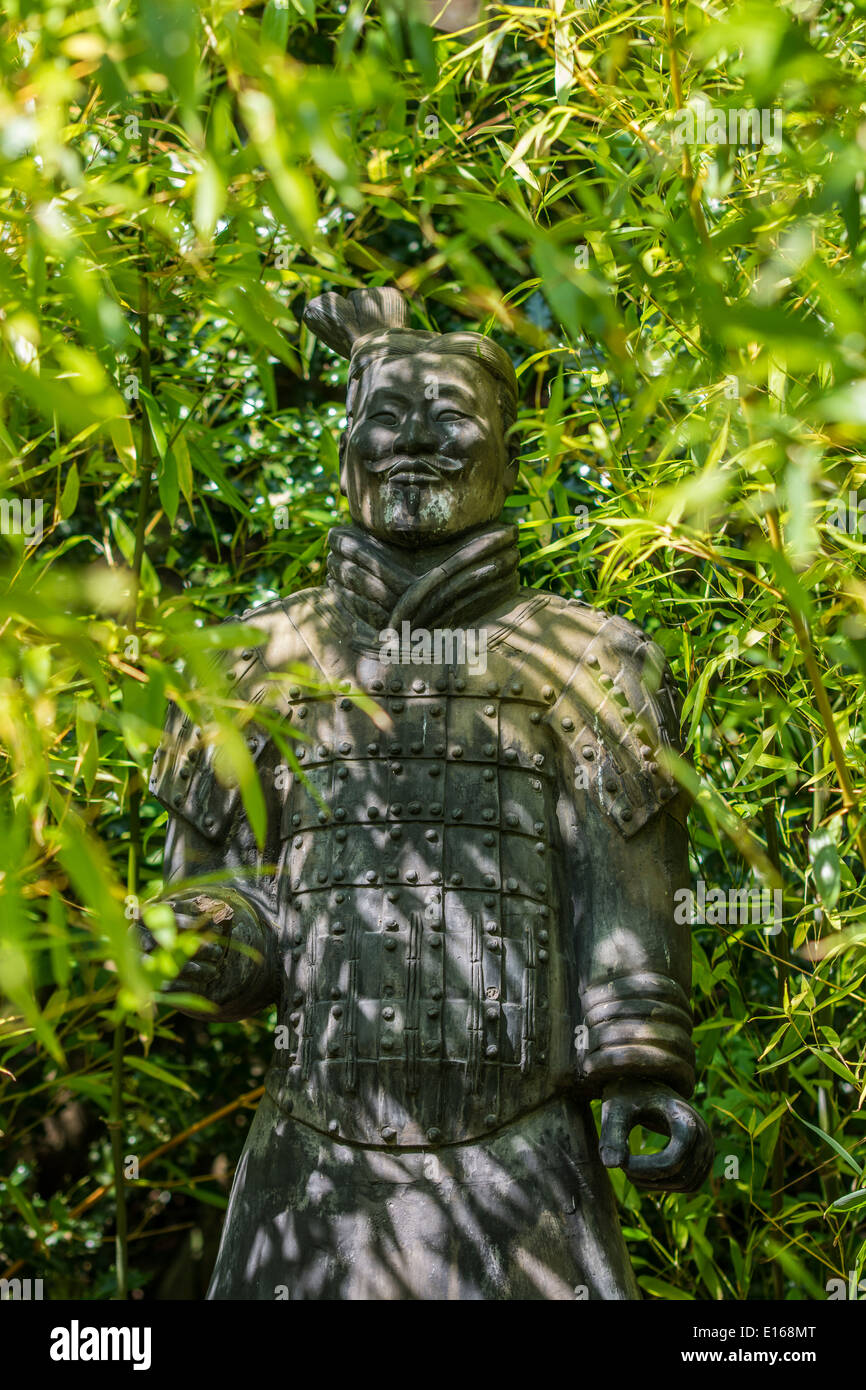 Samurai Warrior statue hidden behind bamboo plants Stock Photo