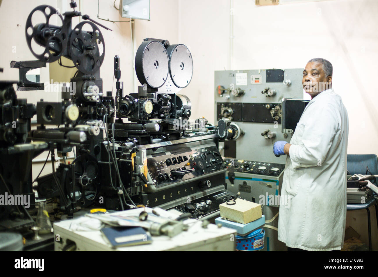 technician in lab processing film with oxberry equipment in background ...