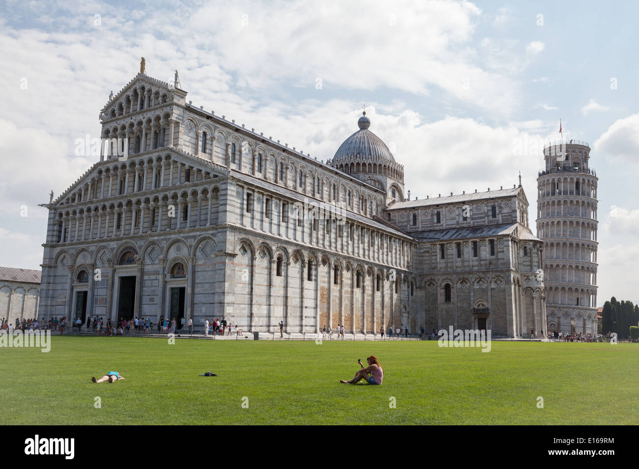 Pisa Cathedral and Leaning Tower of Pisa, on Piazza dei Miracoli in Pisa, Italy, with crowds of tourists strolling around. Stock Photo