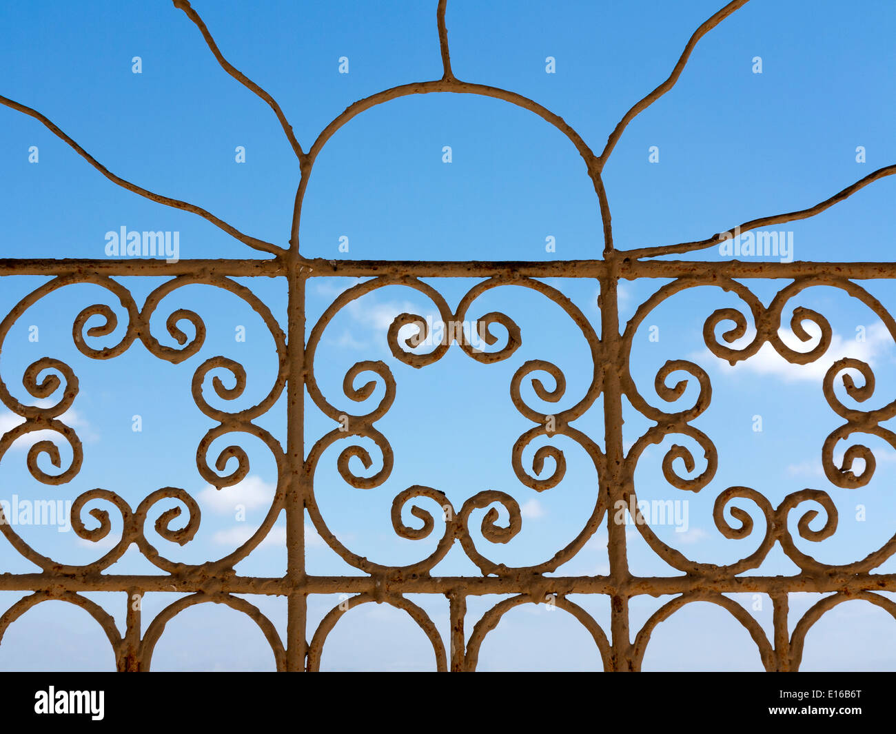 A blue sky seen through a wrought iron window screen Stock Photo Alamy