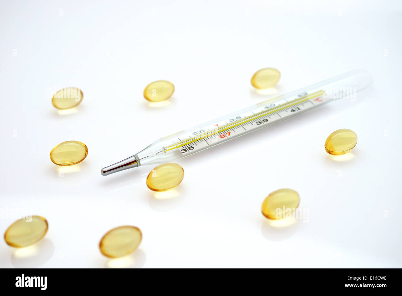 thermometer and yellow tablets Stock Photo