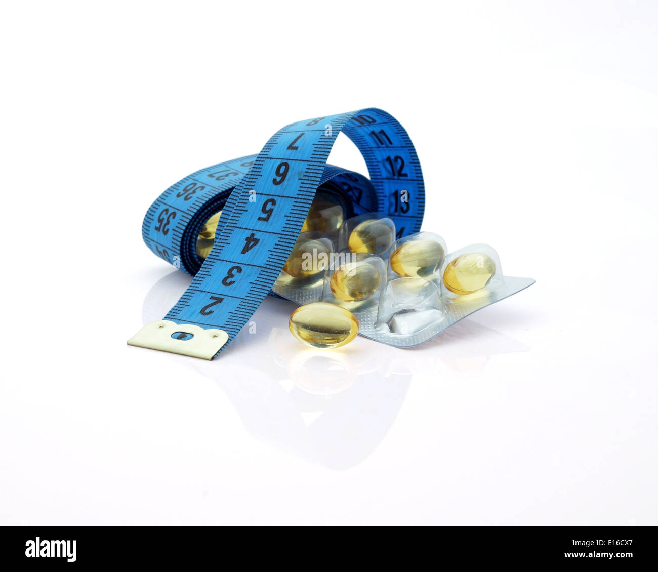 Supplements for Weight Loss. Measuring tape and medicines on white background Stock Photo