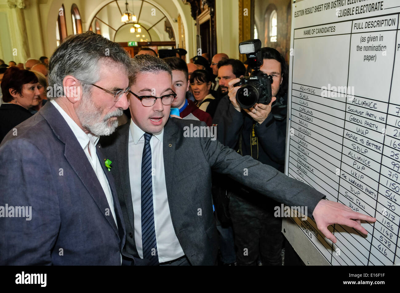Belfast, Northern Ireland. 24 May 2014 - Niall O Donnghaile shows Sinn Fein President, Gerry Adams (TD for Louth), the Sinn Fein results at Belfast City Hall during the count of the Local Government vote for Belfast City Council. Credit:  Stephen Barnes/Alamy Live News Stock Photo