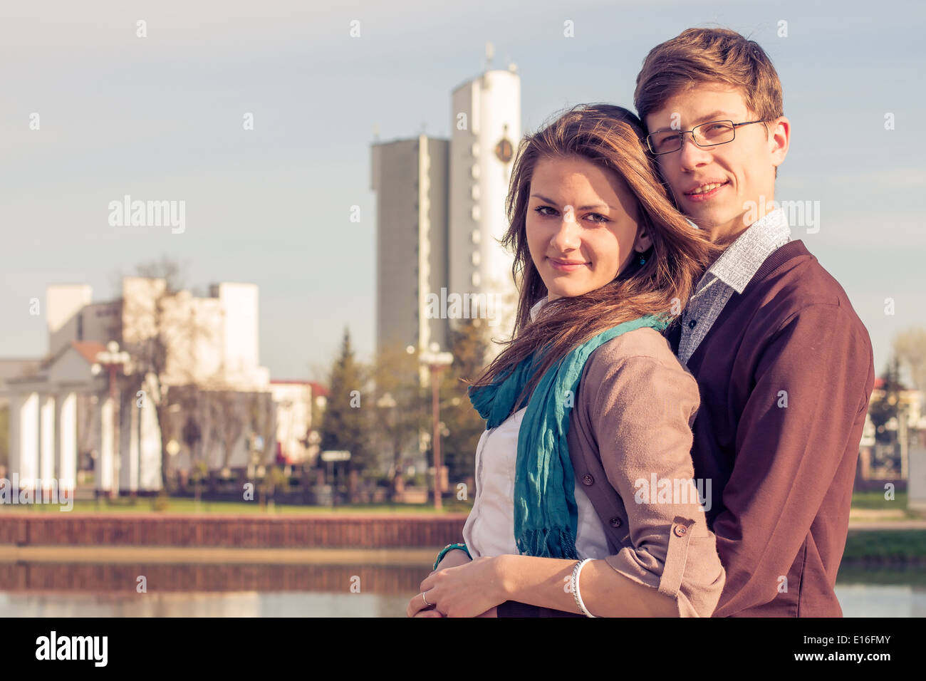 Young fashion elegant stylish couple posing in a European city park. Hipster cute girl with handsome man having fun outdoor. Stock Photo