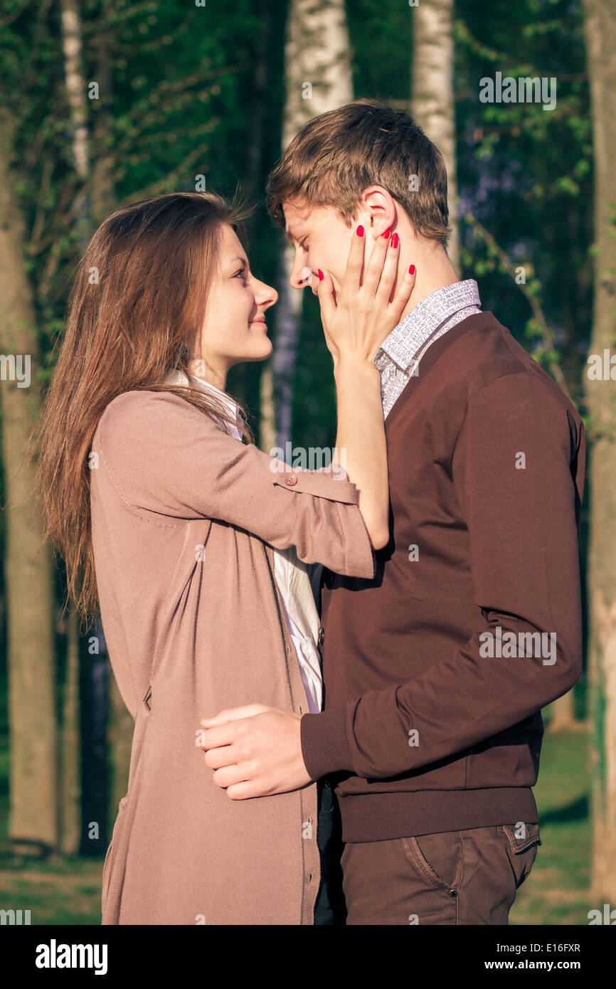 Young fashion elegant stylish couple in love posing in a European city park. Hipster cute girl with handsome man having fun outd Stock Photo