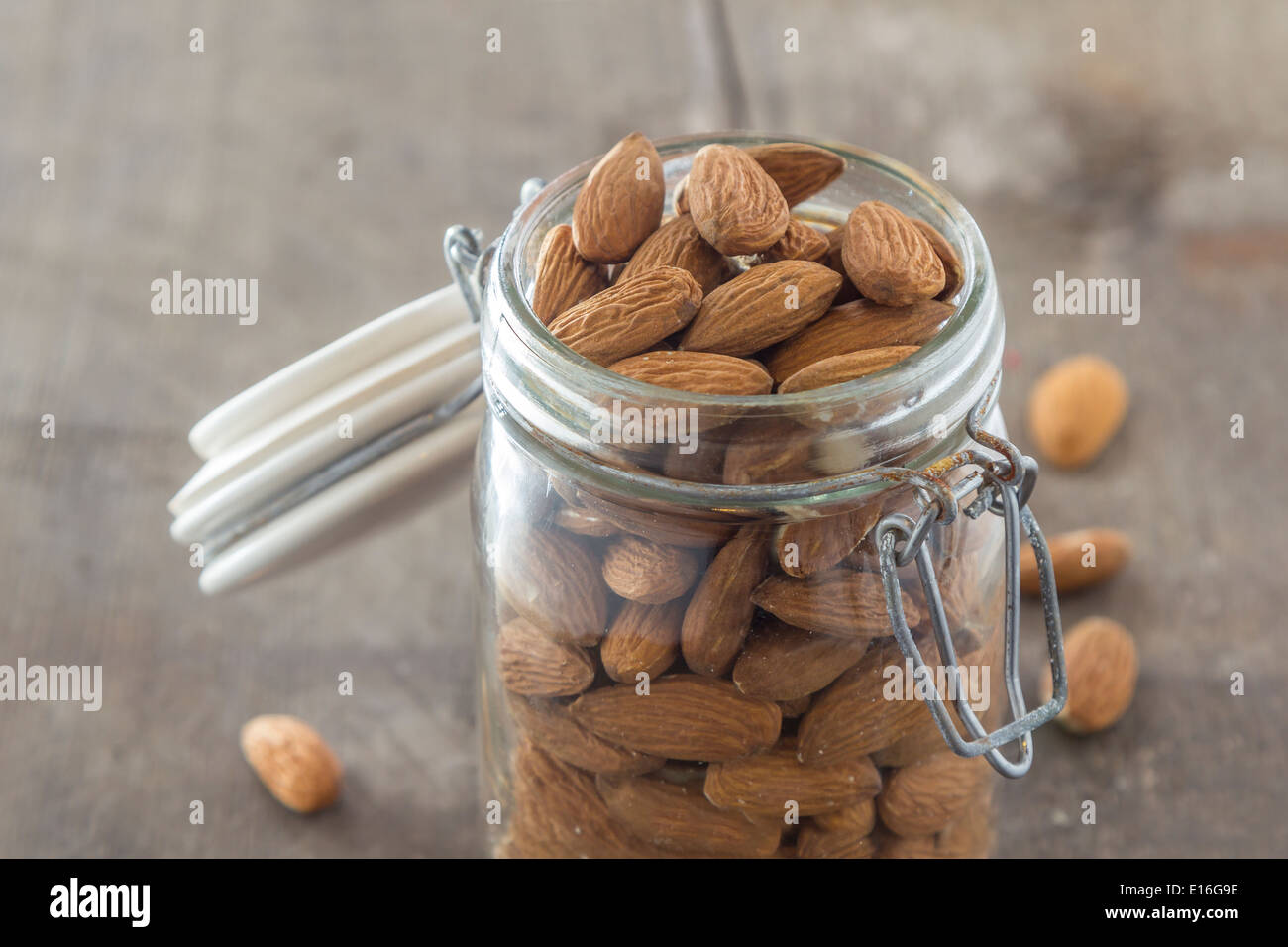 almonds in a jar on a wooden table Stock Photo