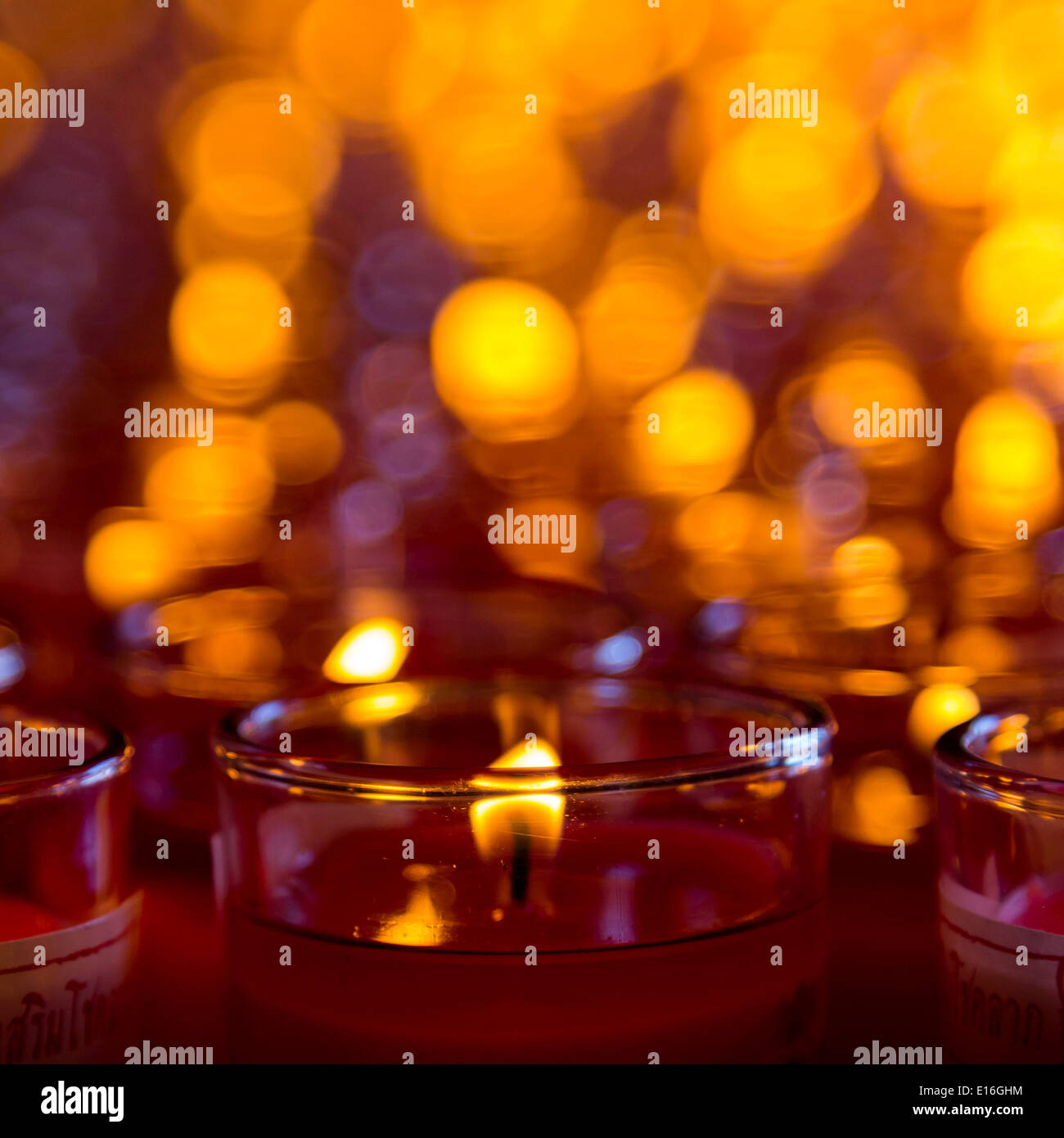 Church candles in red transparent chandeliers Stock Photo Alamy