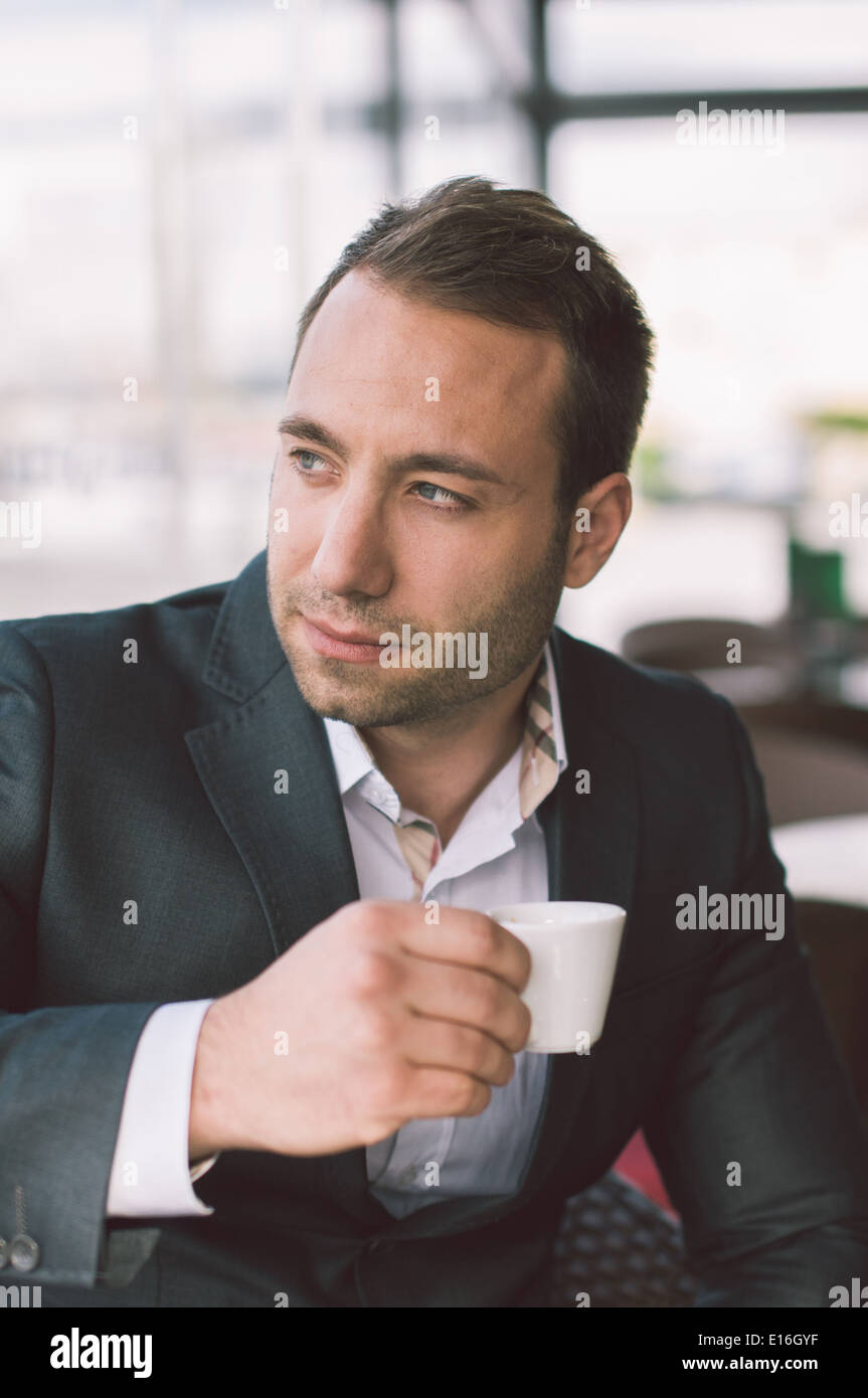 Serious man drinking espresso in caffe Stock Photo