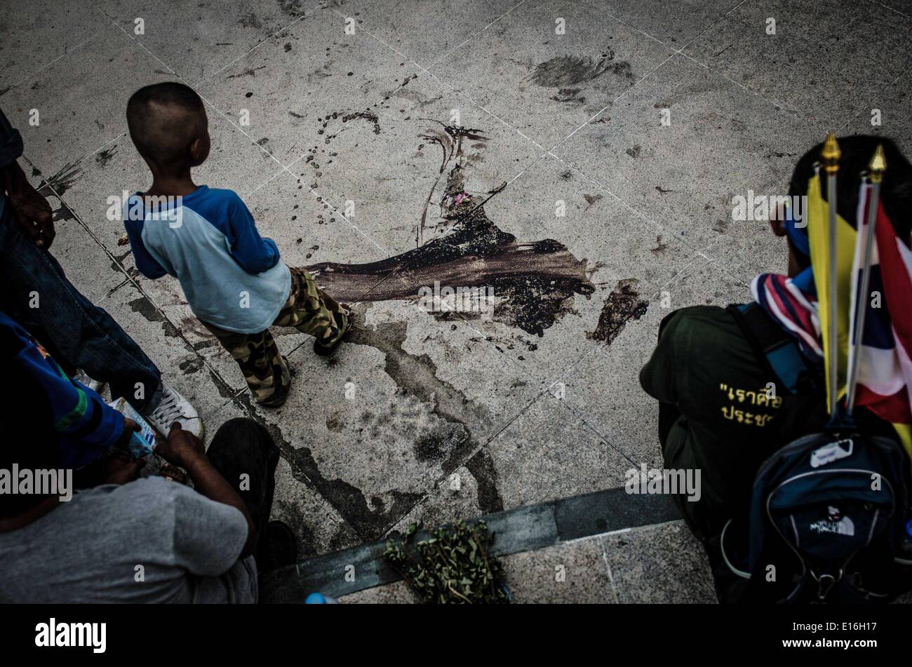Bangkok, Thailand. 22nd Apr, 2014. A young boy looks over the blood covered spot where 3 people were shot dead and a hand grenade exploded in Bangkok. Thailand's army chief announced in a televised address to the nation on May 22 that the armed forces were seizing power after months of deadly political turmoil. The commander-in-chief, who invoked martial law on Tuesday, said the coup was needed to prevent the conflict escalating. © George Nickels/NurPhoto/ZUMAPRESS.com/Alamy Live News Stock Photo
