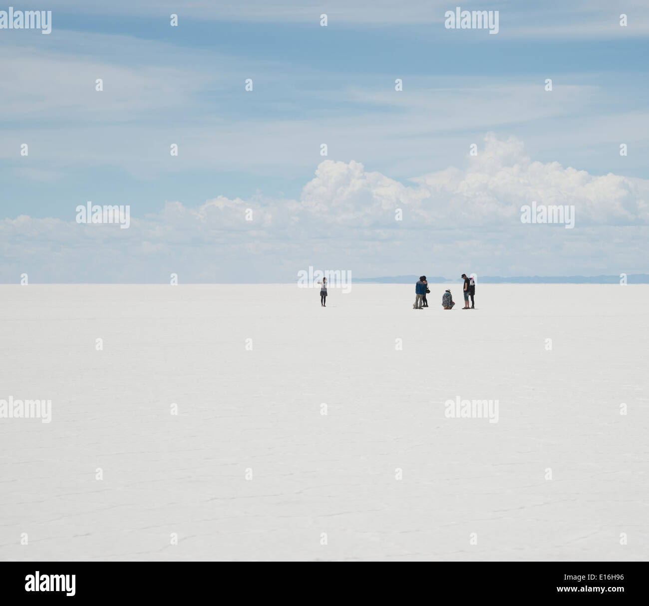 Tourists taking photos on the salt flats near Uyuni, Bolivia Stock Photo