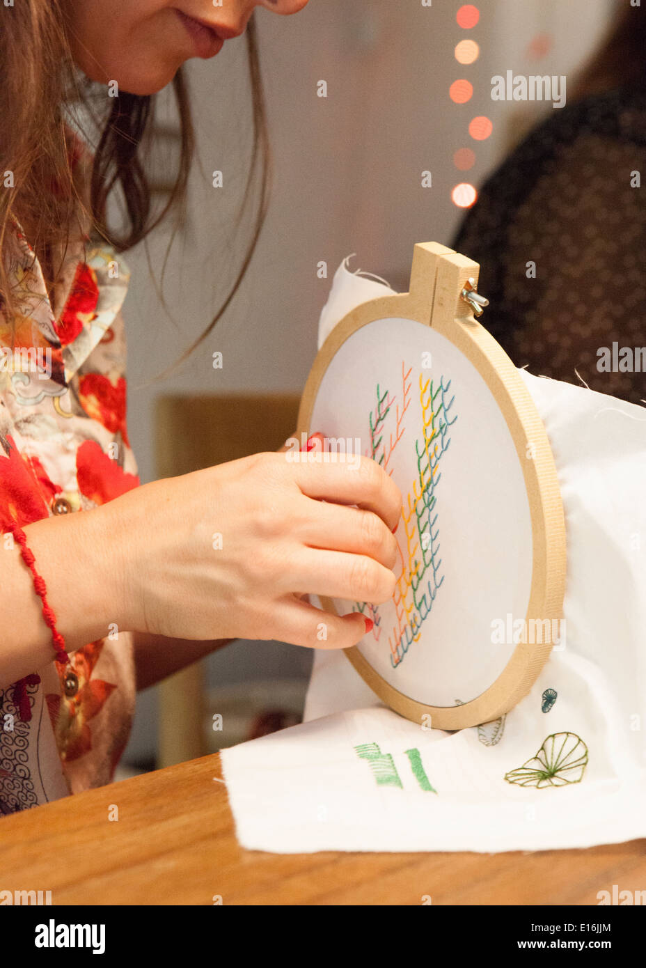 Woman cross stitching Stock Photo