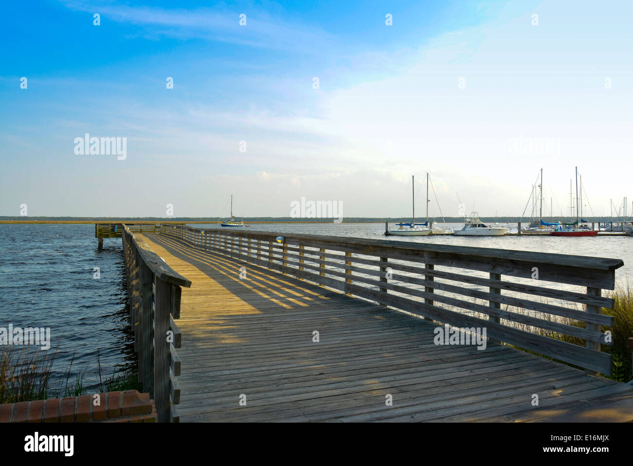 The wooden pier on St. Mary's River boat dock for the Cumberland Island National Seashore ferry excursions in St. Mary's, GA Stock Photo