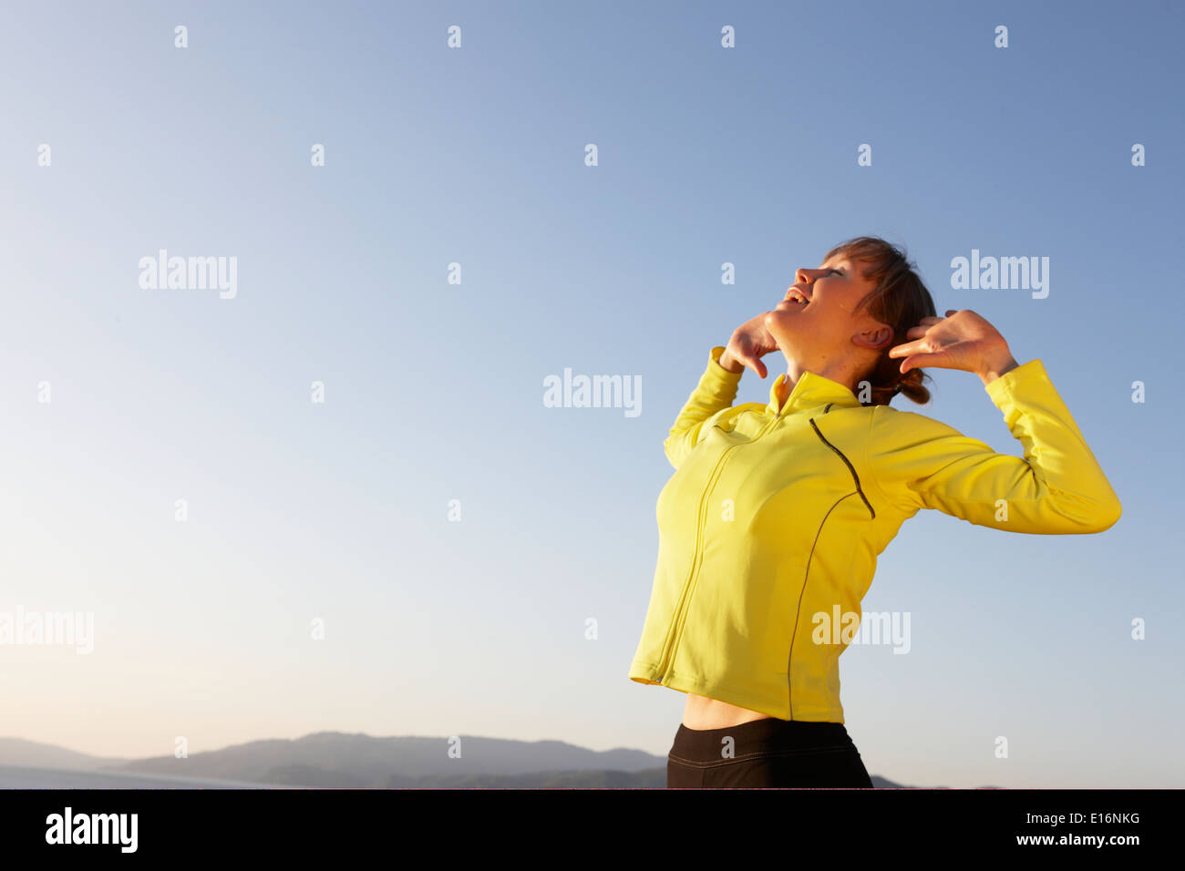 Mid-adult woman stretching Stock Photo