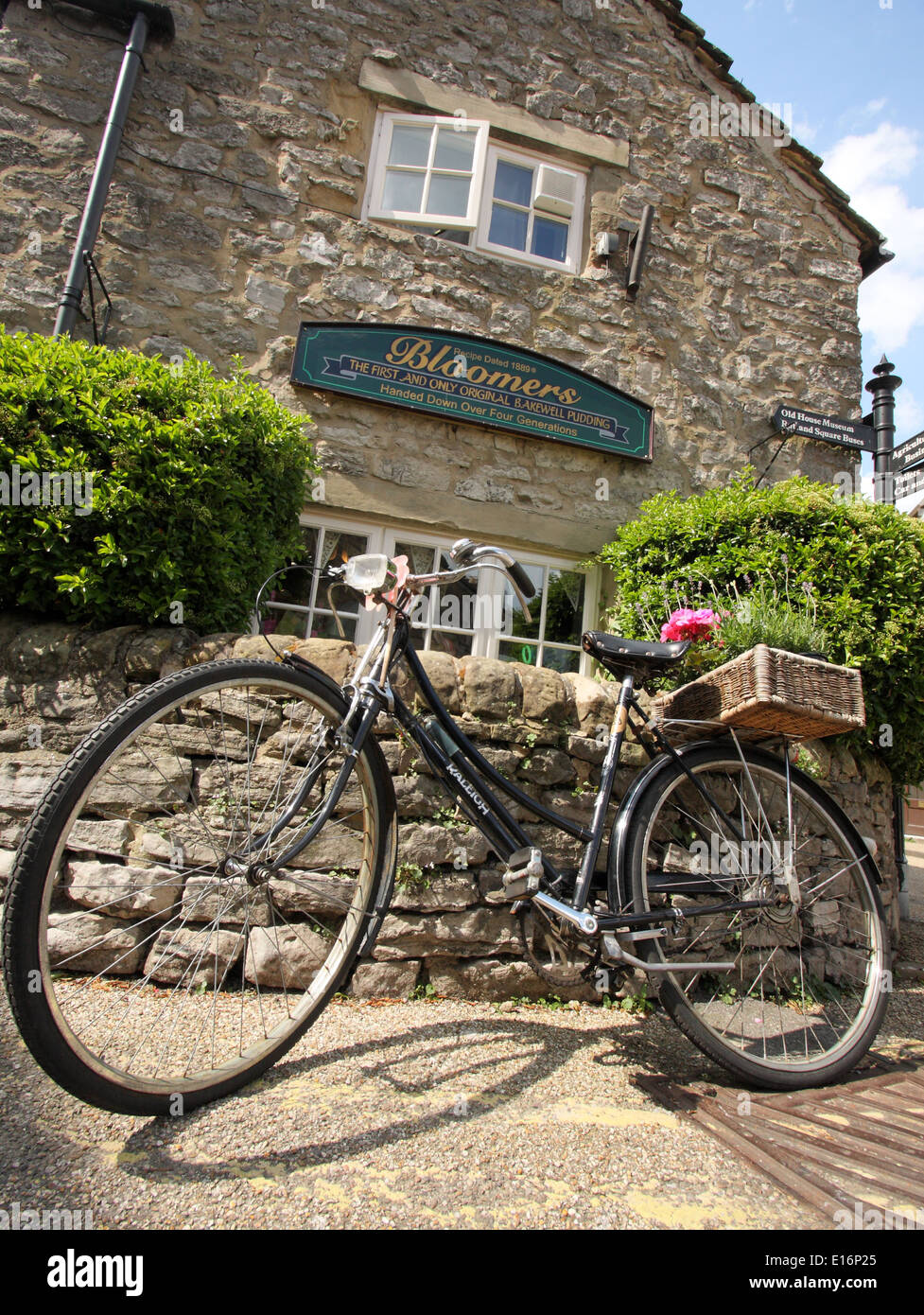 Vintage Raleigh bicycle parked in street outside Bloomers Bakewell Pudding shop, Bakewell Peak District, Derbyshire, England, UK Stock Photo