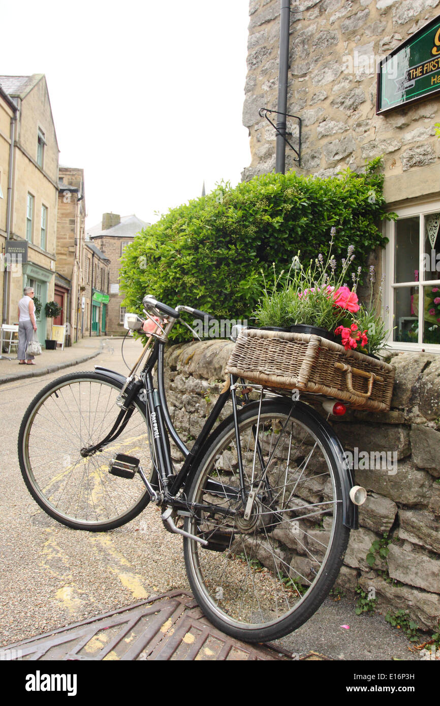 Vintage Raleigh bicycle parked in street outside Bloomers Bakewell Pudding shop, Bakewell Peak District, Derbyshire, England, UK Stock Photo