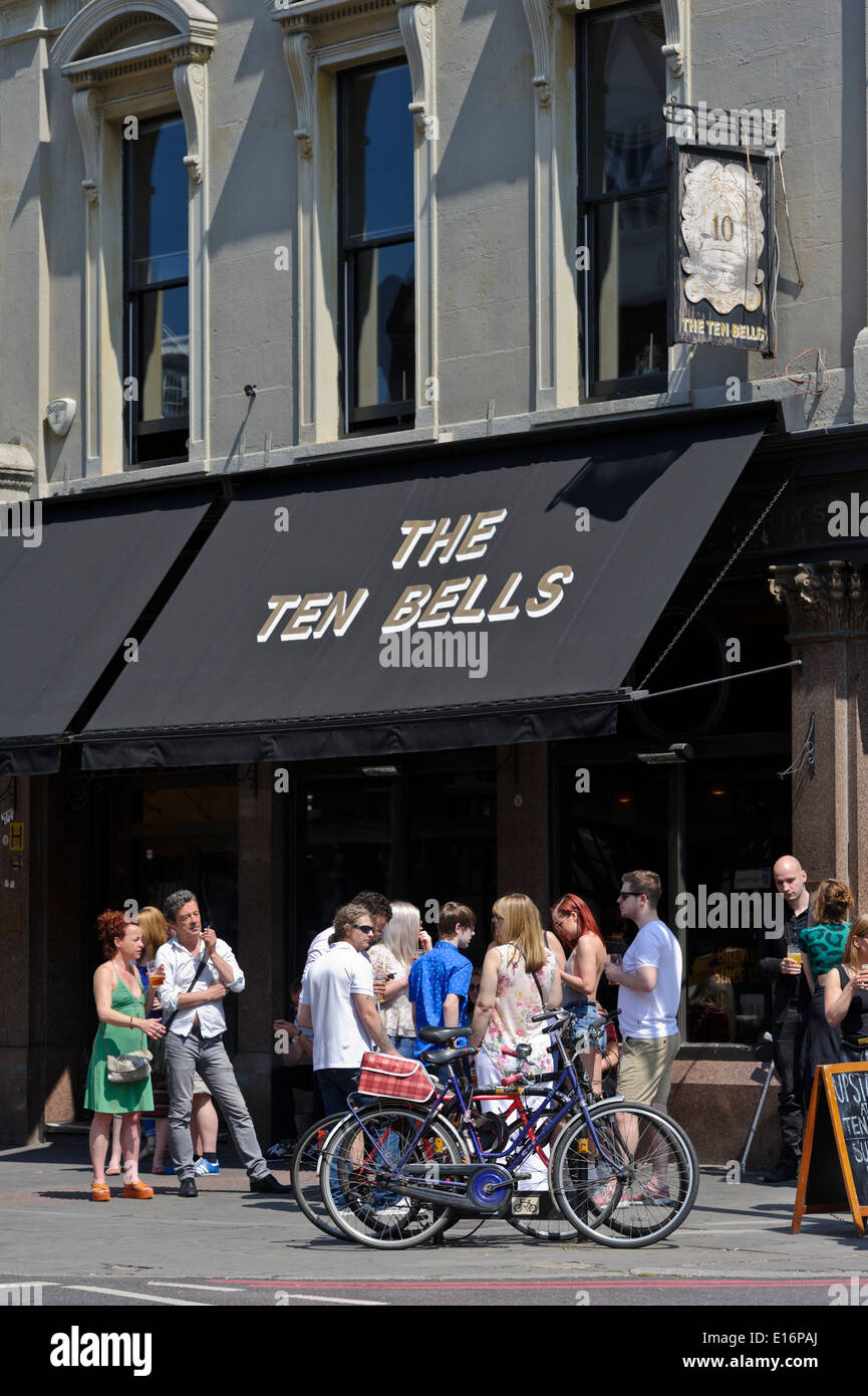 People drinking outside the Ten Bells Public House (Pub), one of the oldest Pubs in London, England, United Kingdom. Stock Photo