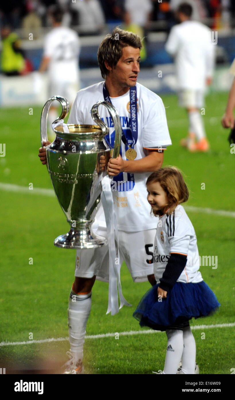 Lisbon, Portugal. 24th May, 2014. Real Madrid's Fabio Coentrao (L) holds the trophy after defeating Atletico Madrid during the UEFA Champions League Final at Luz stadium in Lisbon, capital of Portugal, on May 24, 2014. Real Madrid won 4-1. © Zhang Liyun/Xinhua/Alamy Live News Stock Photo