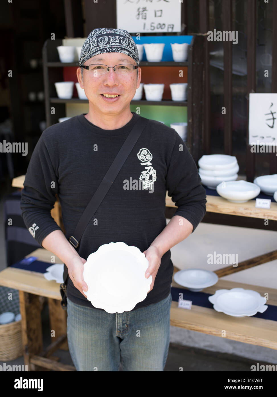 Porcelain artist Nishiyama Katsuaki 西山 勝章 of Imari selling items at Ceramic Festival, Arita, Saga Prefecture Japan. Stock Photo