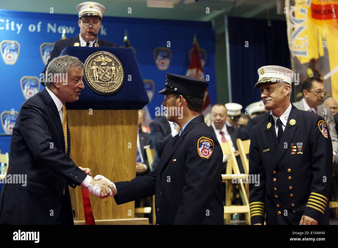 New York, New York, USA. 4th June, 2014. NYC Mayor BILL DE BLASIO, left, awards Firefighter EUGENE SQUIRES of Ladder Company 13 the Thomas A. Kenny Memorial Medal during the FDNY Medal Day 2014 at the 69th Regiment Armory in New York City, New York. © Krista Kennell/ZUMAPRESS.com/Alamy Live News Stock Photo