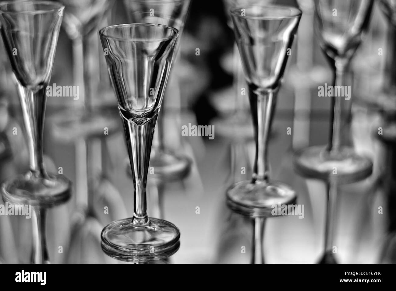 Spirit glass on blurry mirrored background with other glasses Stock Photo