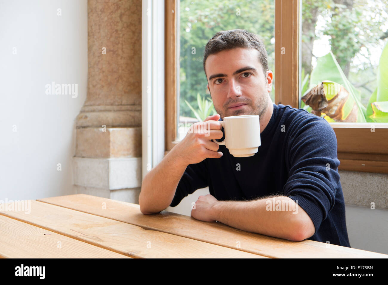 A man drinking a cup of tea Stock Photo - Alamy