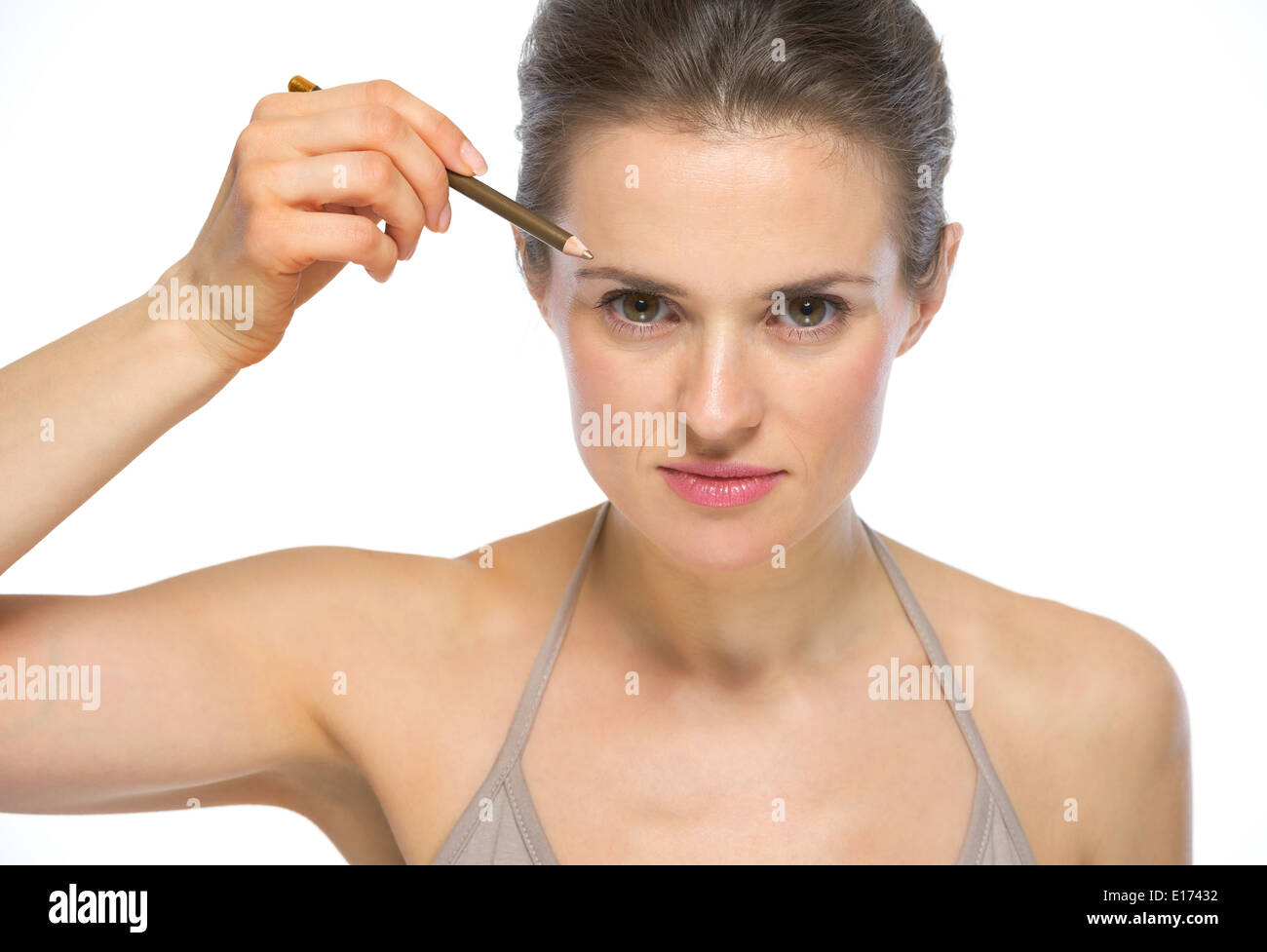 Portrait of young woman using eyebrows pencil Stock Photo