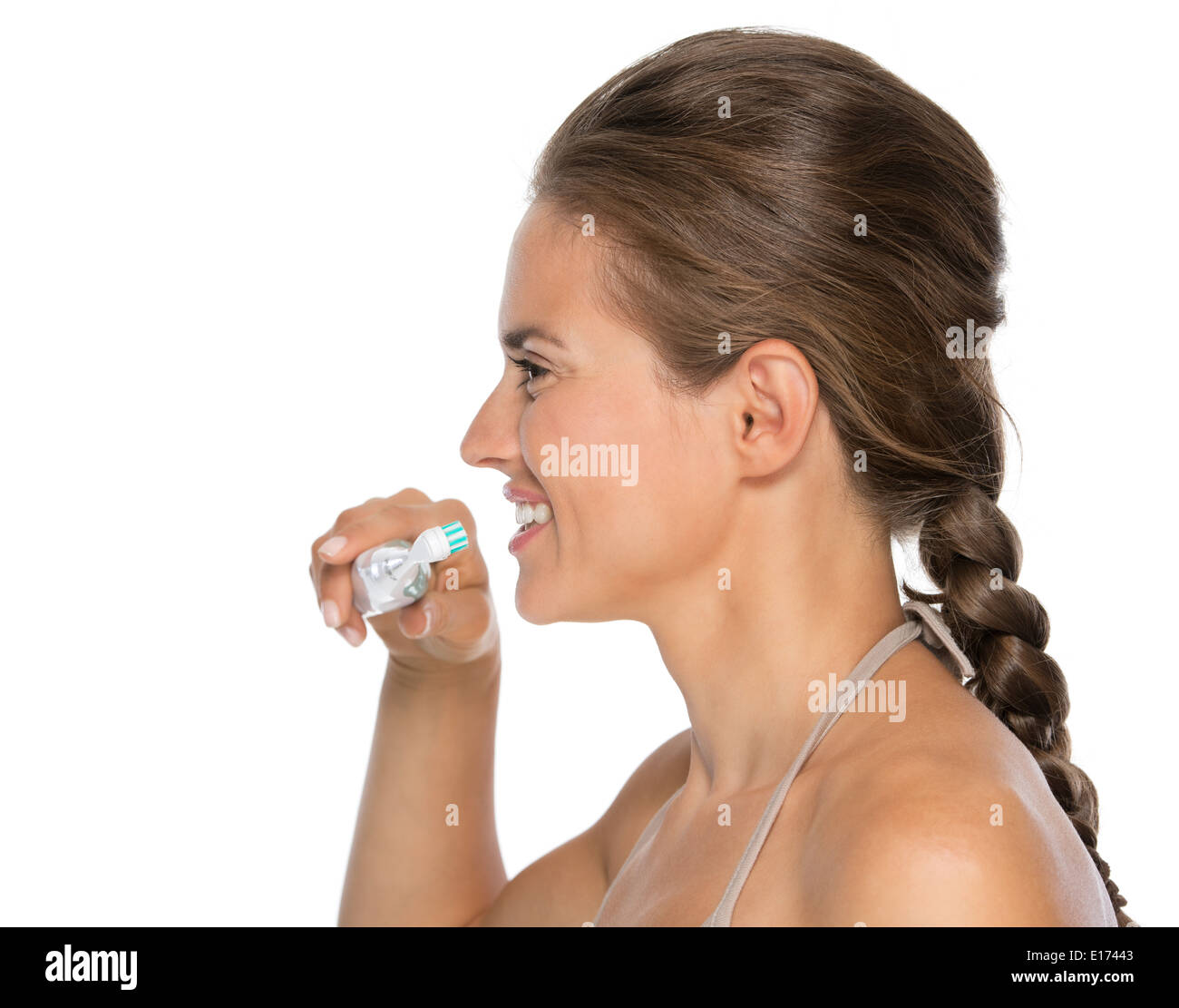 Profile portrait of young woman brushing teeth Stock Photo