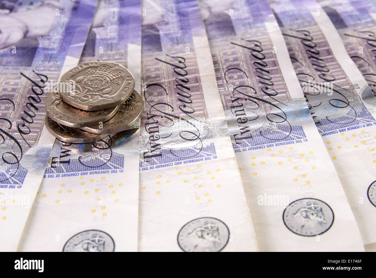 British Pound Notes and stack of coins Stock Photo