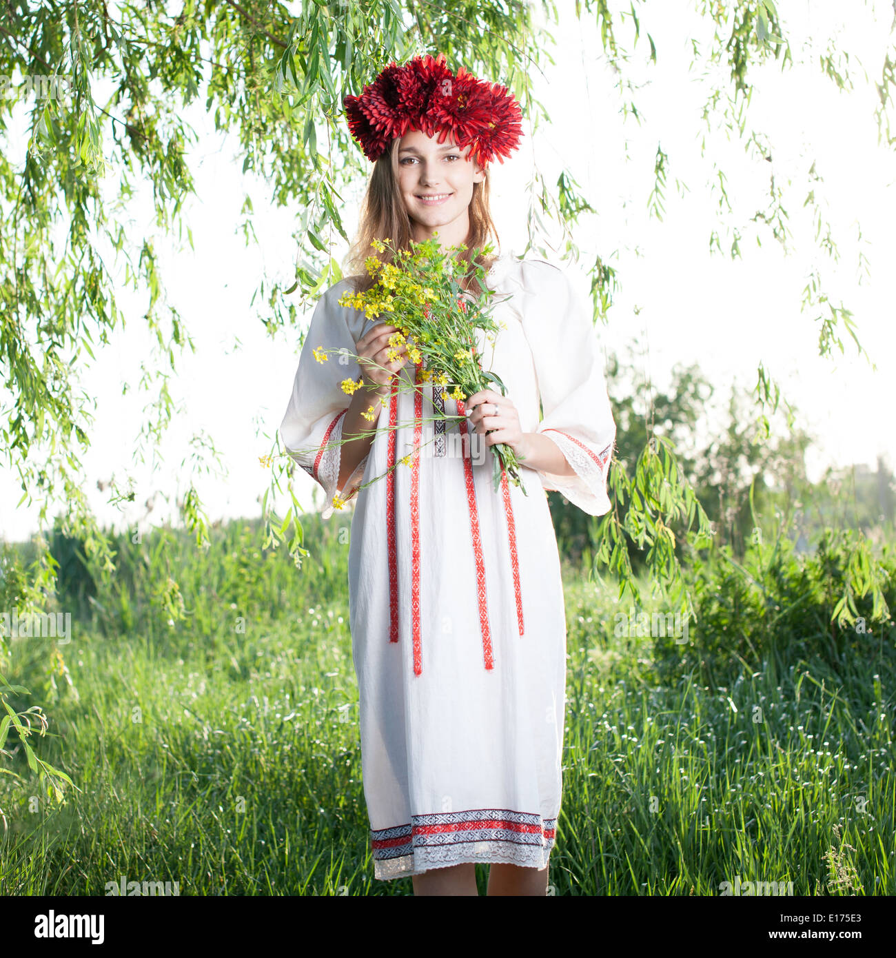 Young woman posing in traditional ukrainian costume outdoors Stock
