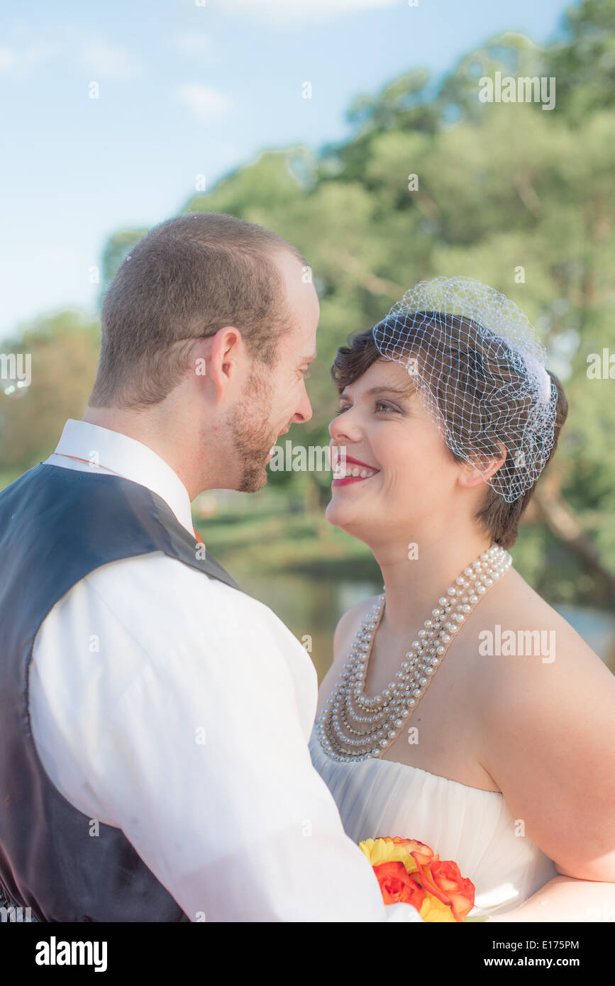 Smiling newly wed couple in an outdoor setting. Stock Photo