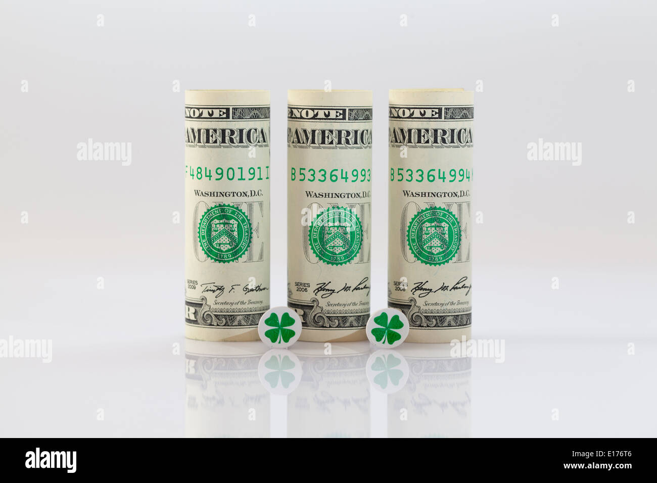 Rolls of dollar bills and golf tees Stock Photo - Alamy