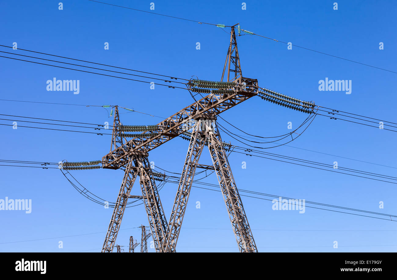 High voltage electric tower against blue sky Stock Photo - Alamy