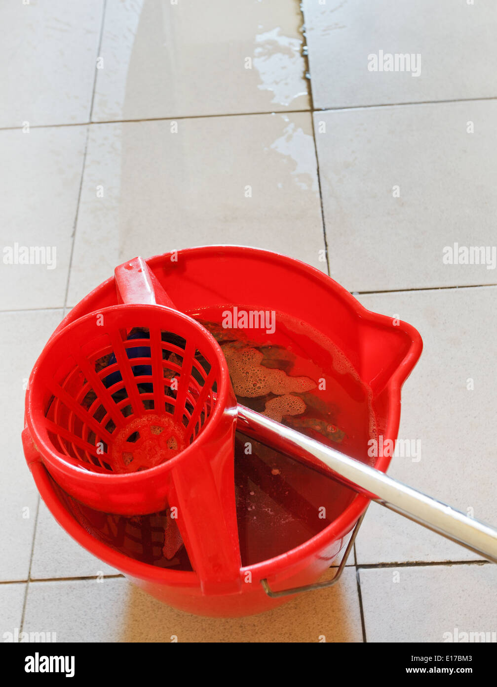 https://c8.alamy.com/comp/E17BM3/swab-in-red-bucket-with-washing-water-and-cleaning-tile-floor-E17BM3.jpg