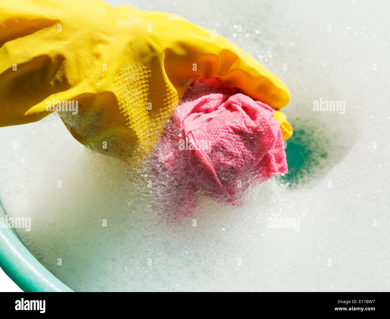 Hand Soapy Rag hand in yellow rubber glove rinsing rag in soap suds water Stock Photo ...