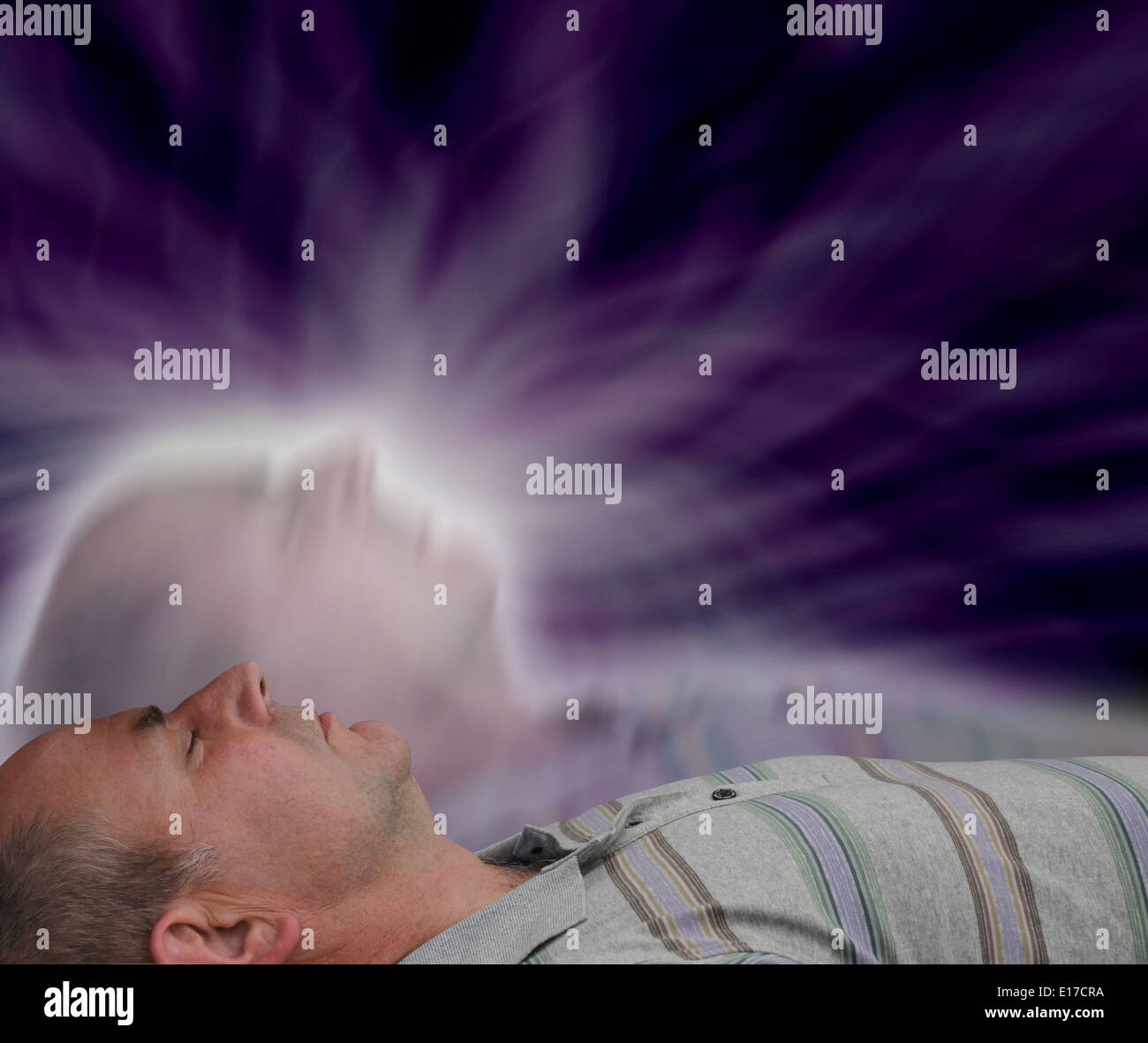 Male lying supine with eyes closed experiencing astral projection Stock Photo