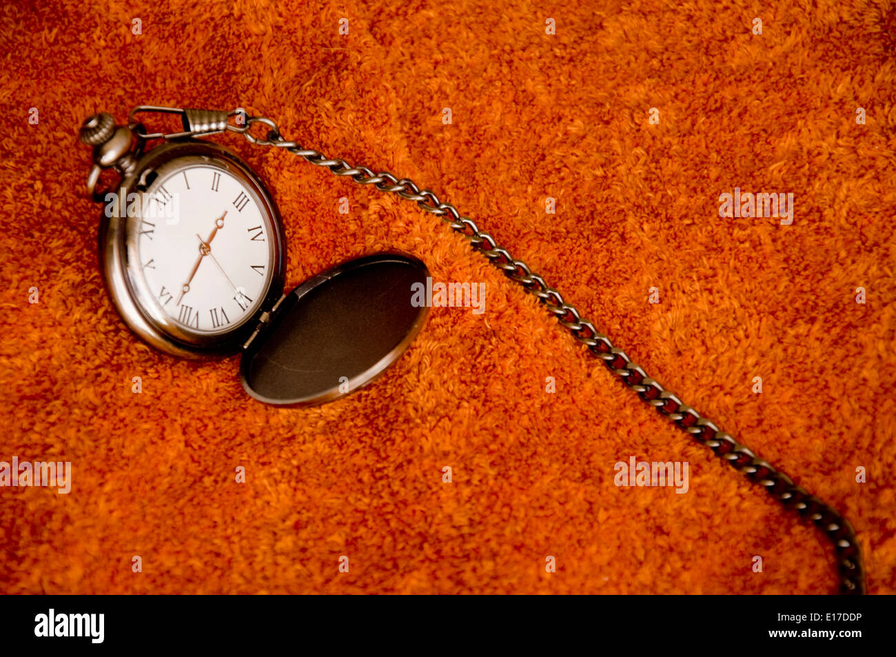 Vintage hand clock over a brown background Stock Photo