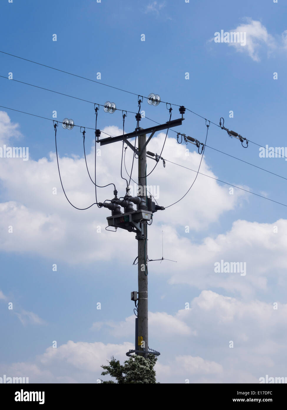 A remotely operated 440V transformer circuit breaker and isolator in a pole mounted 3 phase 11kV overhead electrical power line. Stock Photo