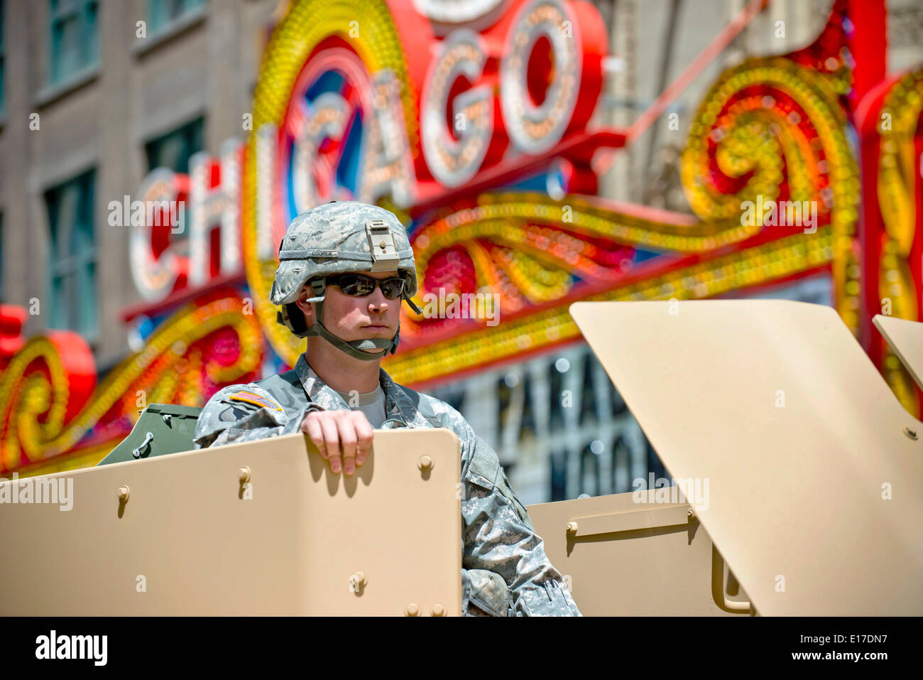 A US Army soldier rides in the turret of an up-armored Humvee past the Chicago Theatre during a Memorial Day Parade down State Street  May 24, 2014 in Chicago, Illinois. Stock Photo