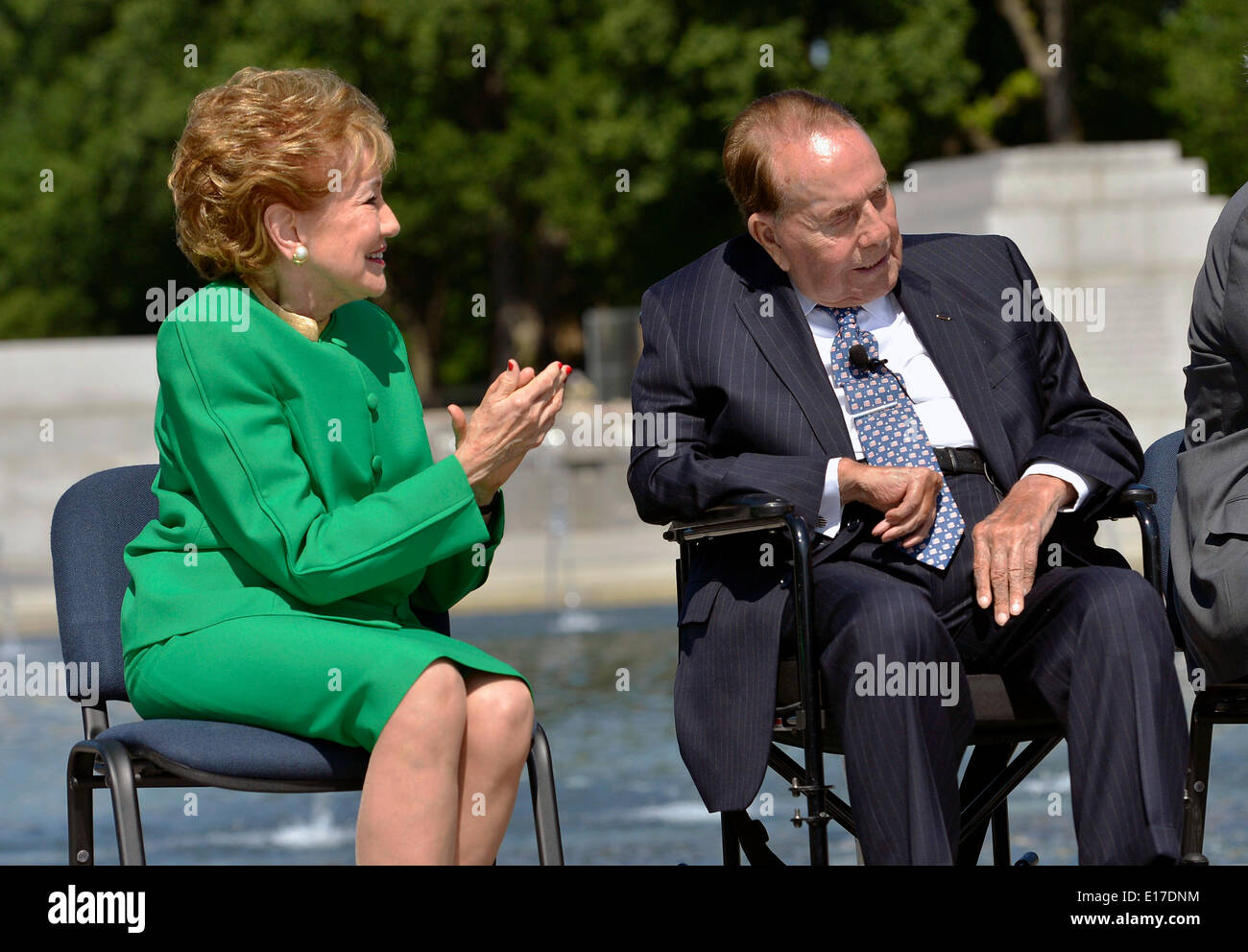 Former Senator Elizabeth Dole applauds as her husband former Senator and presidential candidate Bob Dole, is recognized by Secretary of Defense Chuck Hagel during his keynote address at a ceremony marking the tenth anniversary of the WW II Memorial May 24, 2014 in Washington, D.C. Stock Photo
