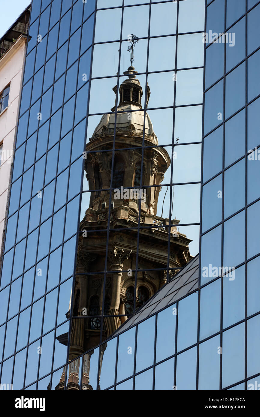 Santiago Metropolitan Cathedral reflected in modern glass clad office block Chile Stock Photo