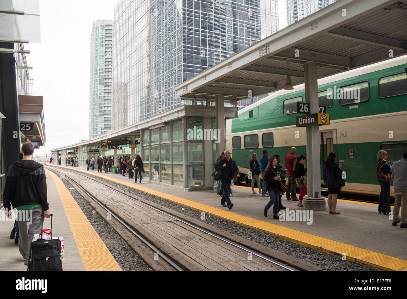 GO train at the platform at Toronto's Union Station where commuter passengers are waiting for trains. Stock Photo