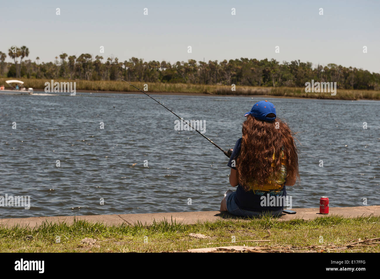 A young girl fishing on the Crystal River from Fort Island Park