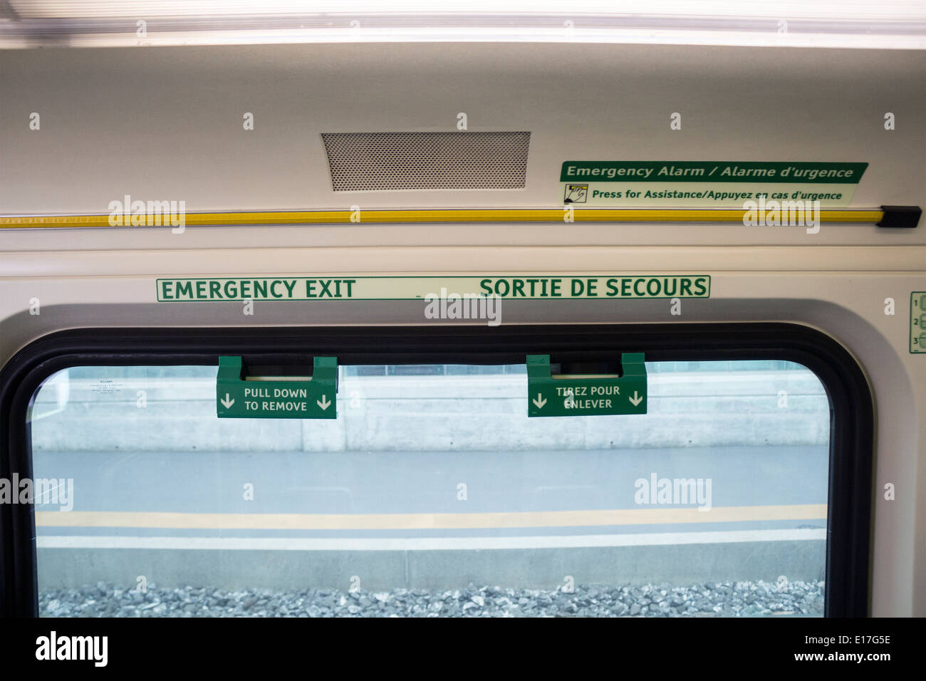 Emergency exit signs in both English and French on the GO train in