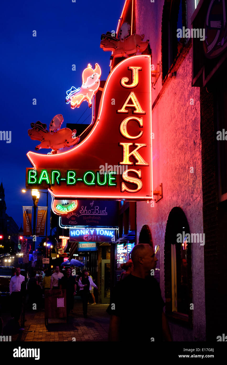 Neon signs at Jacks Bar-B-Que illuminate Broadway Street in Downtown Nashville, Tennessee Stock Photo