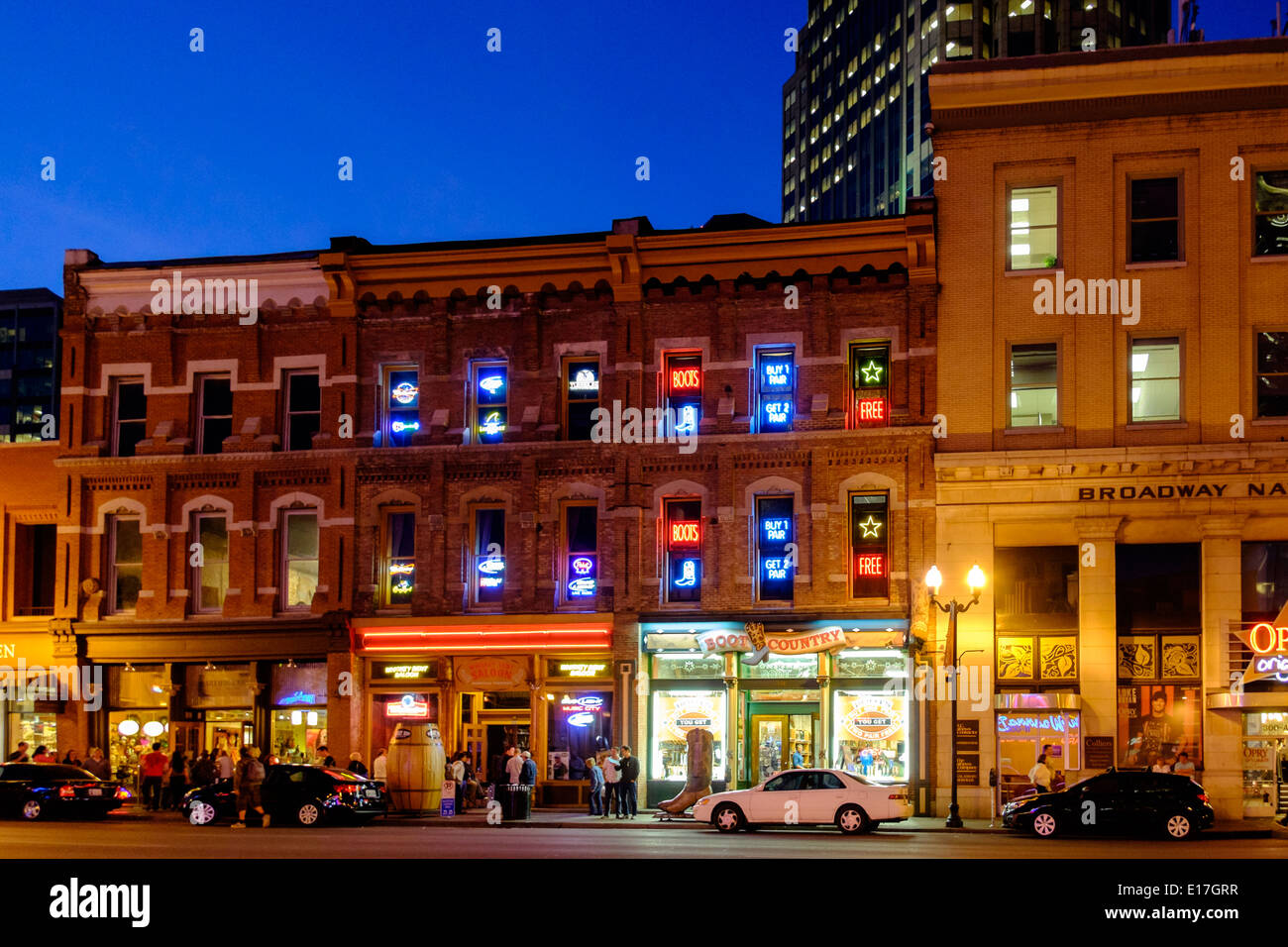 Neon signs illuminate Broadway Street at night in Downtown Nashville, Tennessee Stock Photo