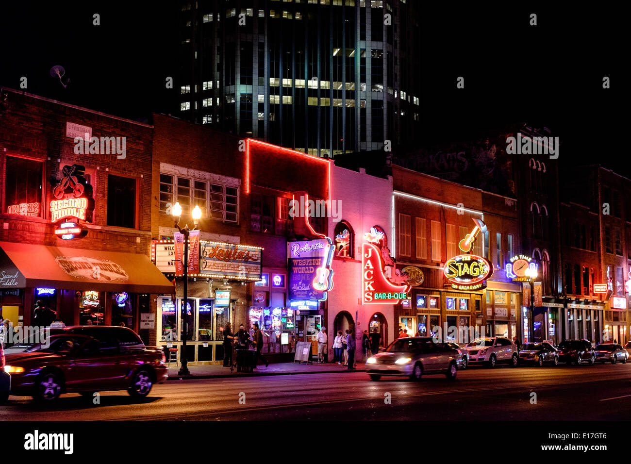 Neon signs illuminate Broadway Street at night in Downtown Nashville, Tennessee Stock Photo