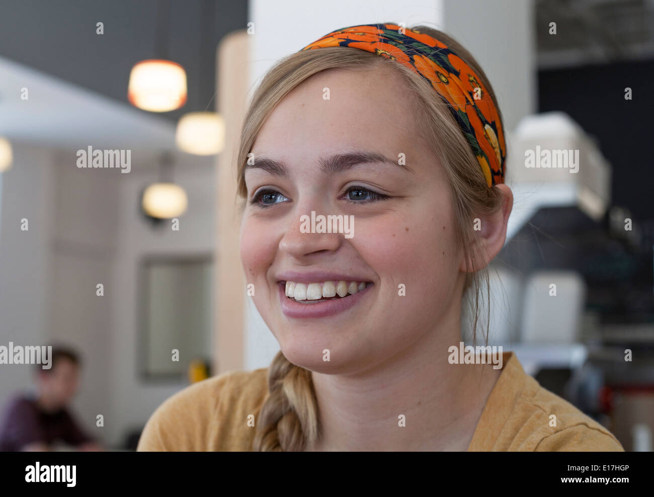 A cashier smiles at a restaurant in Chicago, Illinois, USA. Stock Photo